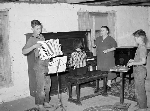 MUSIC LESSONS, 1940. A homesteaders wife teaching music lessons in her home in Pie Town