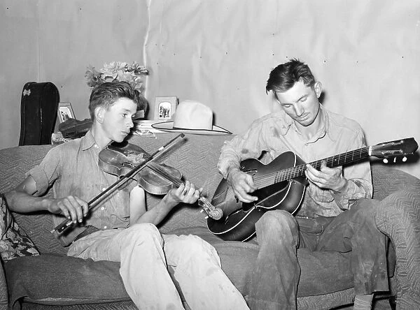 MUSICIANS, 1940. A farmer and his brother playing music at home in Pie Town, New Mexico