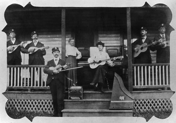 MUSICIANS, c1905. A group of American musicians on the front porch of their home
