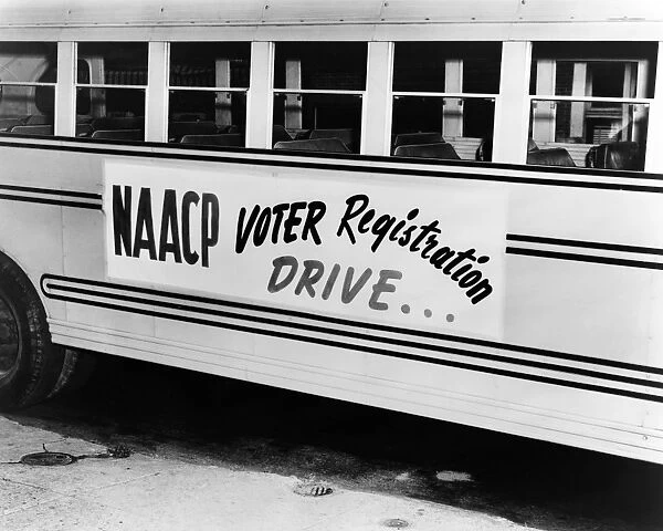 NaCP VOTER DRIVE, c1962. A school bus bearing a sign for an NaCP voter registration drive