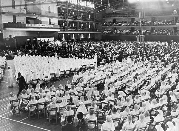 NATION OF ISLAM, 1964. Elijah Muhammad leading an assembly of Nation of Islam adherents