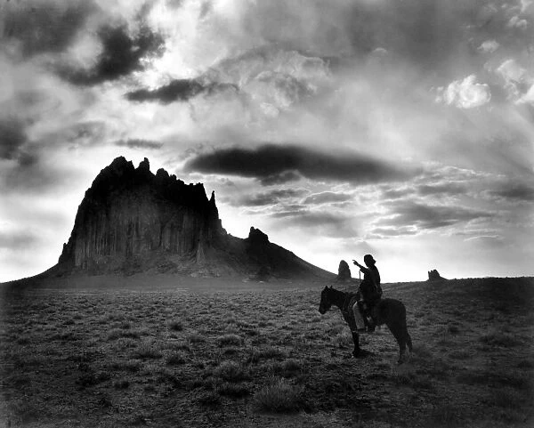 NAVAJO MAN, c1915. The Dawn of the Day. A Navajo man on horseback, gesturing toward a butte in the southwestern United States. Photograph by William Carpenter, c1915