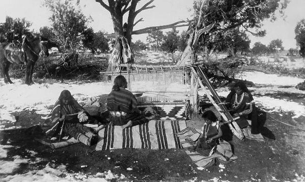 NAVAJO WEAVERS, 1893. Charlie, a Navajo man, weaving a blanket on a horizontal