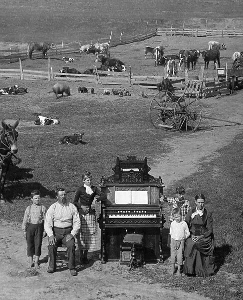 NEBRASKA: FRONTIER FAMILY. The family of David Hilton posing next to their organ on their farm near Weissert, Custer County, Nebraska. Photographed by Solomon D. Butcher, 1887