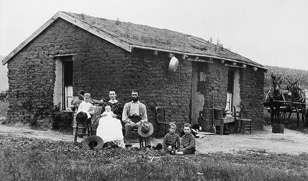 NEBRASKA: HOMESTEADERS. A pioneer family poses in front of their sod house in Nebraska