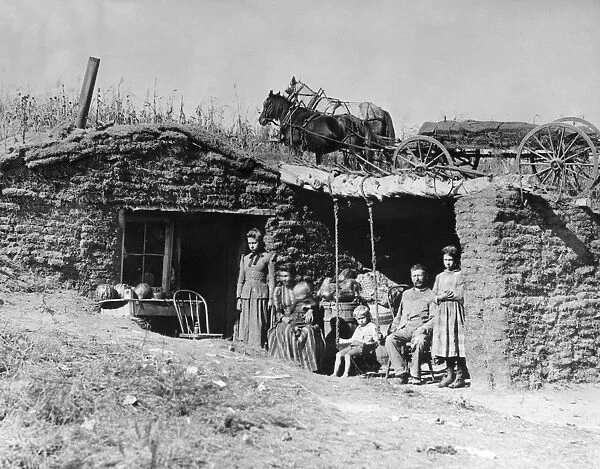 NEBRASKA: SETTLERS, 1892. A homesteader family in front of their sod house dugout