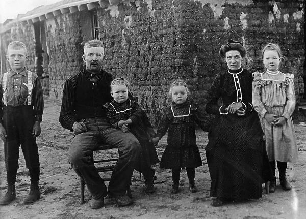 NEBRASKA: SETTLERS, 1900. A homesteader and family in front of their sod house in Cherry County