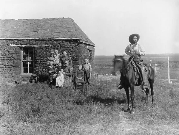 NEBRASKA: SETTLERS, 1901. A homesteader and his family in front of their sod house