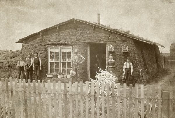 NEBRASKA: SETTLERS, c1886. Family of homesteaders standing in front of their sod