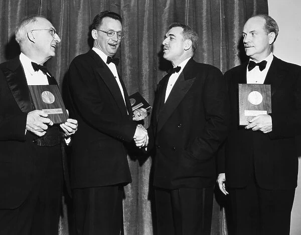 NELSON ALGREN (1909-1981). American writer. Algren (second from left) being congratulated by book critic Ralph Morrissey after being presented with the National Book Award for fiction at the Waldorf-Astoria Hotel in New York City, 16 March 1950, with fellow award winners William Carlos Williams (for poetry, left) and Ralph L. Rusk (for nonfiction, right)