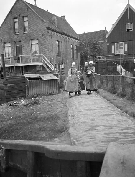 NETHERLANDS, c1910. Women and children in a town in the Netherlands. Photograph by Arnold Genthe