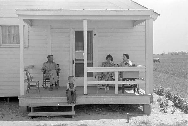 NEW HOME, 1938. Former tenant farmer and family on the front porch of their new home, Missouri