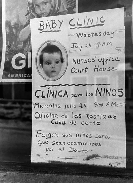 NEW MEXICO: BABY CLINIC. Sign in post office window advertising a baby clinic in Taos, New Mexico