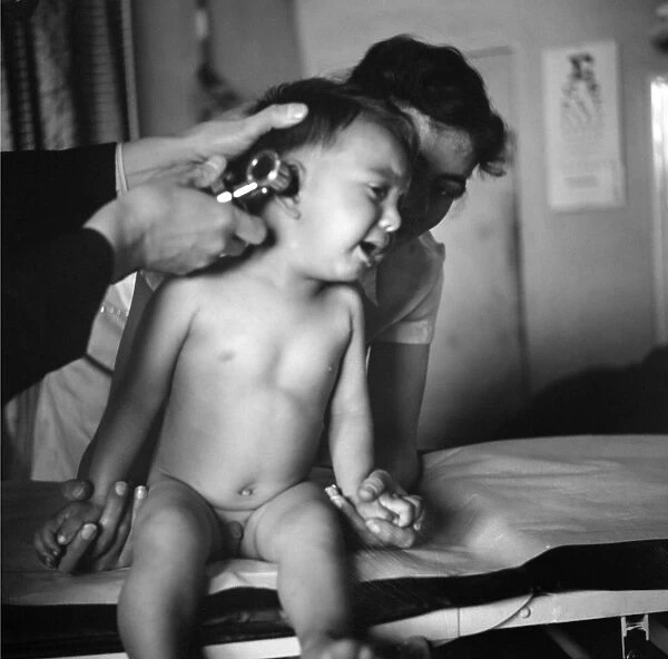 NEW MEXICO: HEALTH CLINIC. A baby being examined in a clinic operated by the Taos