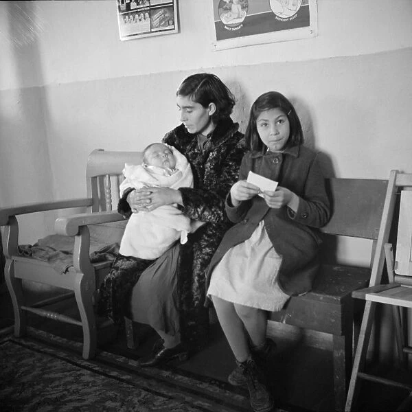 NEW MEXICO: HEALTH CLINIC. A mother with her children in the waiting room of the