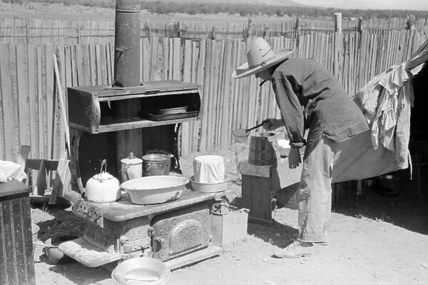 NEW MEXICO: HOMESTEADER. Mrs. Faro Caudill pouring water over milk bucket to keep