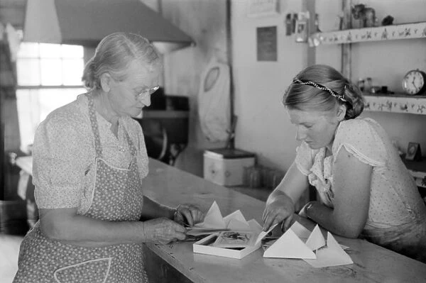 NEW MEXICO: STORE, 1940. Lois Stagg and her mother looking at greeting cards in Pie Town