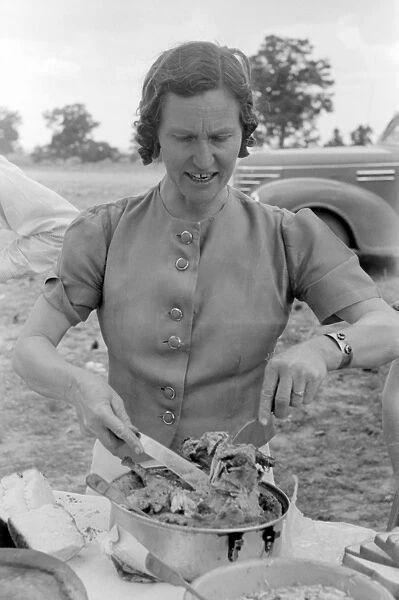 NEW MEXICO: WOMEN, 1940. A homesteader serving chicken and dressing at a community