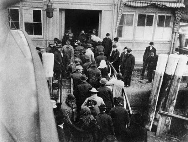 NEW YORK: BATTERY, 1902. Immigrants disembarking from the ferry boat from Ellis