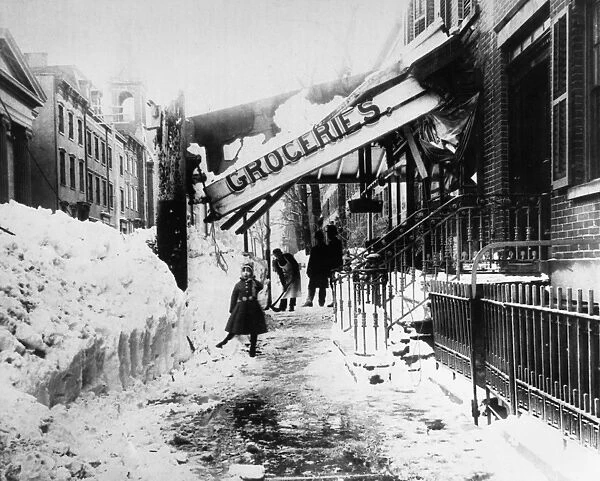 NEW YORK: BLIZZARD OF 1888. A man shovels snow beneath the collapsed awning of