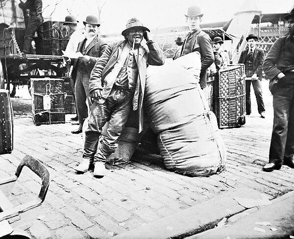 NEW YORK: IMMIGRANTS, 1896. A European immigrant leaning against a large sack upon
