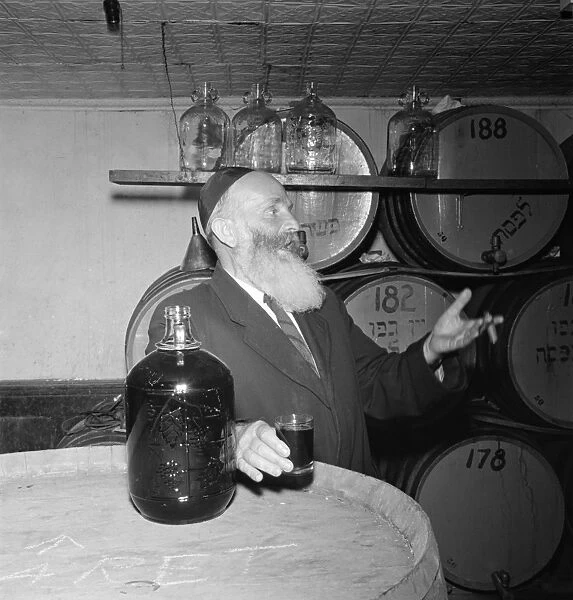 NEW YORK: RABBI, 1942. A rabbi inspecting the wine a kosher wine shop in the New York City