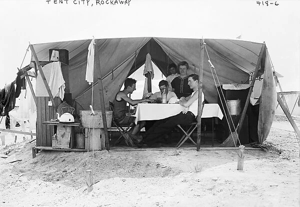 NEW YORK: ROCKAWAY, 1910. Men playing cards in a tent city on the beach at Rockaway, New York