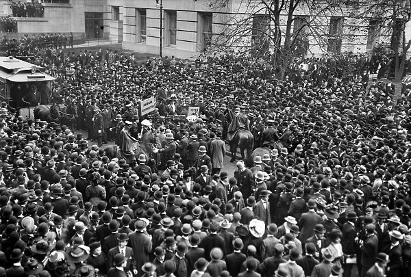 NEW YORK: SUFFRAGETTES. A crowd watching a suffragette demonstration outside City
