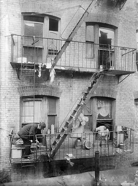 NEW YORK: TENEMENT, c1910. A public health inspector searching for mosquito breeding