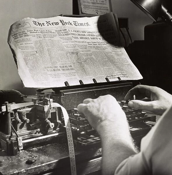 NEW YORK TIMES OFFICE, 1942. A copy reader at the telegraph desk in the New York Times office