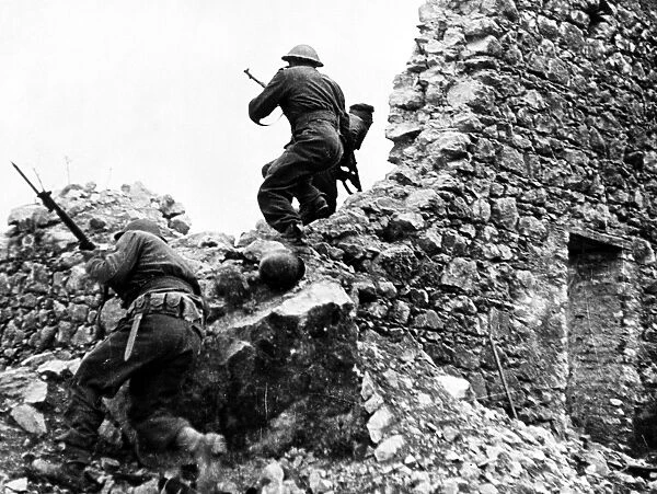 New Zealand infantryman on the lookout for enemy snipers at Cassino, Italy. Photographed 1944