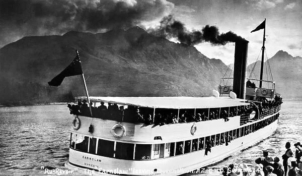 NEW ZEALAND: VACATIONERS. The steamboat Earnslaw, loaded with vacationers, leaving