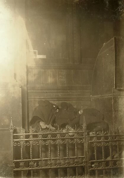 NEWSBOYS SLEEPING, 1909. Three newsboys aleep on a heating grate used for ventilation