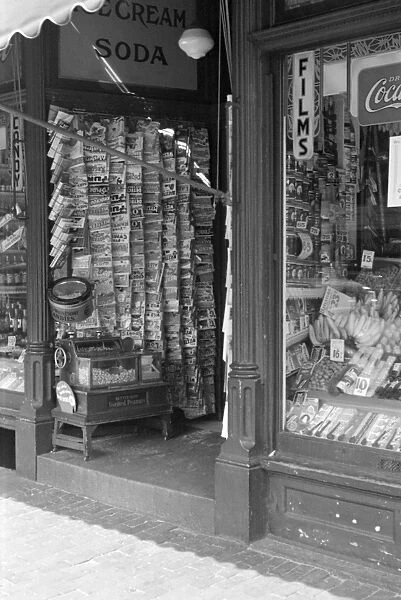 NEWSSTAND, 1937. A newsstand in Manchester, New Hampshire. Photograph by Edwin Locke