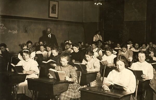 NIGHT SCHOOL, 1909. Working immigrant girls in an evening class for all nationalities in Boston