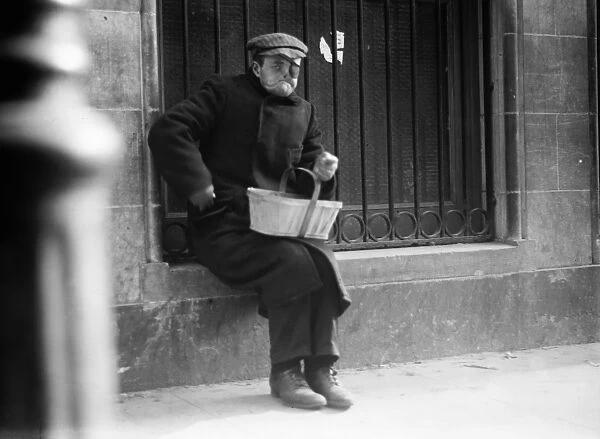 NYC: BEGGAR, c1915. A disfigured man begging in New York City. Photograph, c1915