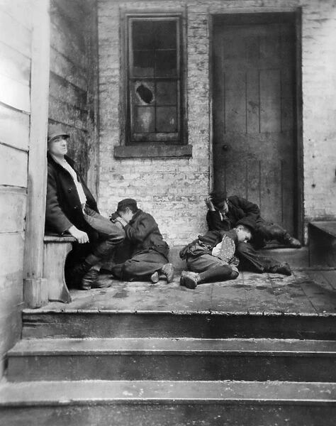 NYC: TENEMENT LIFE. Boys sleeping on the porch of a tenement building in New York City