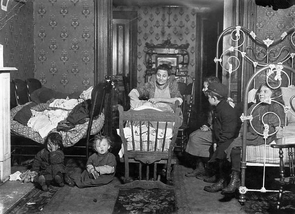 NYC: TENEMENT LIFE, c1910. A New York City tenement family. Photograph by Lewis Hine