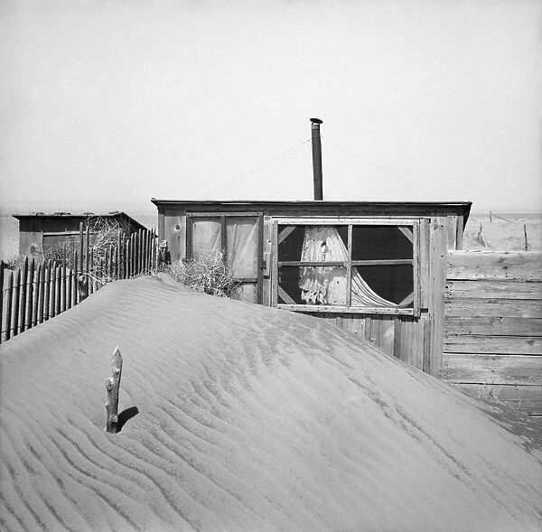 OKLAHOMA: DUST STORM, 1936. Sand piled up in front of an outhouse on a farm in Cimarron, Oklahoma
