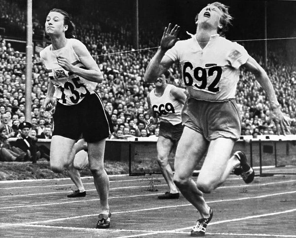 OLYMPIC GAMES, 1948. Fanny Blankers-Koen of the Netherlands (right) and Maureen Gardner (left) of England finishing the 80 meter hurdle event at Wembley Stadium, London, England, 4 August 1948
