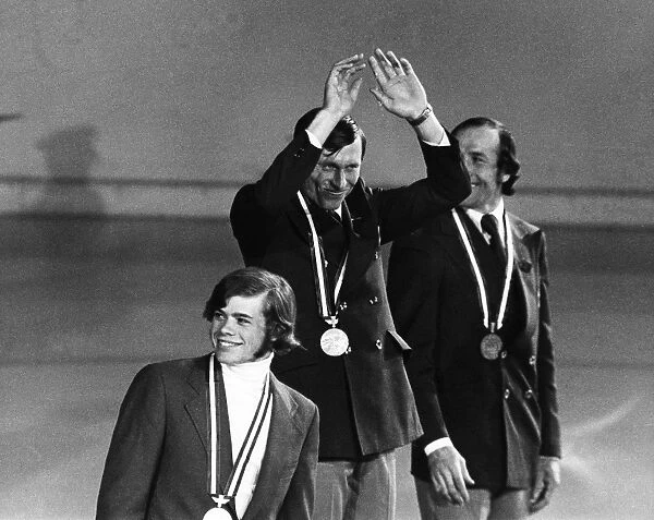 OLYMPIC GAMES, 1976. Sergey Savelyev of the Soviet Union waves from the winners podium at the Winter Olympic Games in Innsbruck, Austria, 6 February 1976, after receiving the gold medal for the mens 30 kilometer cross-country ski race. Also shown are silver medalist Bill Koch of the USA (foreground) and bronze medalist Ivan Garanin of the Soviet Union