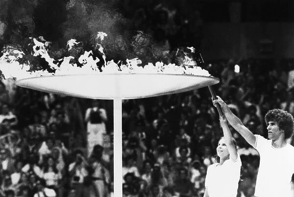 OLYMPIC GAMES, 1976. Torch bearers Sandra Henderson (age 16) and Stephane Prefontaine (age 15) lighting the Olympic flame at the opening ceremonies of the Summer Olympic Games in Montreal, Quebec, Canada, 17 July 1976