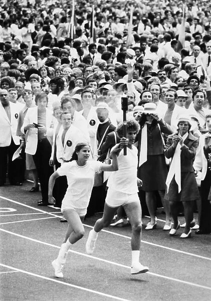 OLYMPIC GAMES, 1976. Torch bearers Sandra Henderson (age 16) and Stephane Prefontaine (age 15) on their way to light the Olympic flame at the opening ceremonies of the Summer Olympic Games in Montreal, Quebec, Canada, 17 July 1976