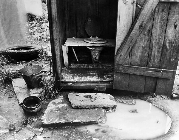OUTDOOR TOILET, 1935. A typical outhouse in the slum district of Washington, D. C. Photograph by Carl Mydans, September 1935