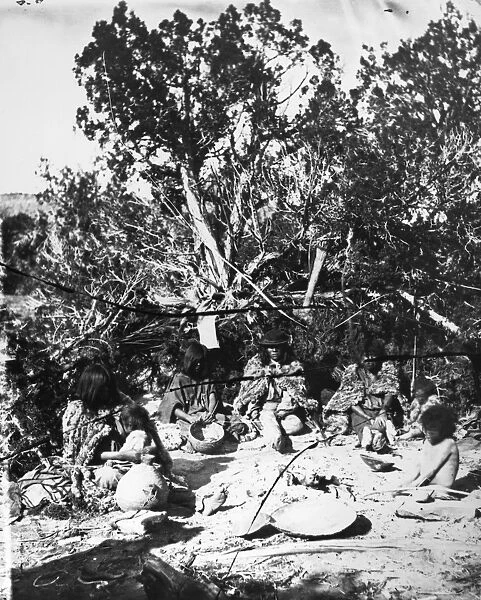 PAIUTE CAMP, c1873. A Paiute family seated around a campfire on the Kaibab Plateau