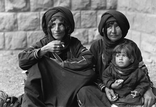 PALESTINE: BEDOUIN WOMEN. Bedouin women and a child wait outside a Scottish mission