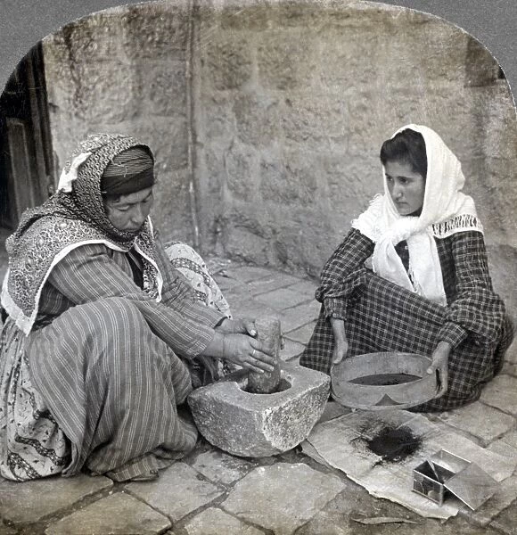 PALESTINE: GRINDING COFFEE. Two Palestinian women grinding coffee. Stereograph, c1905