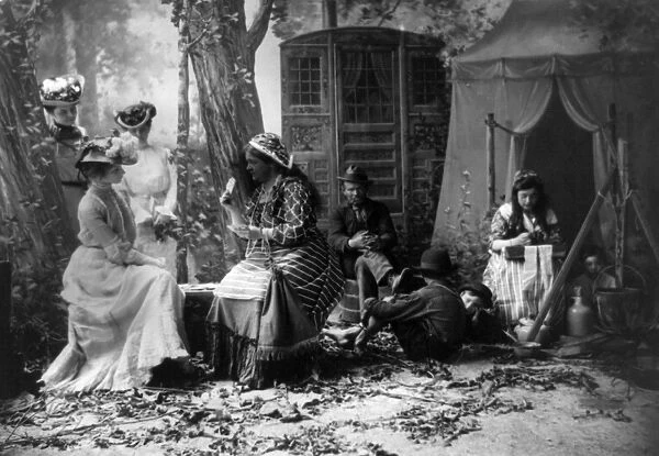 PALM READING, c1902. Staged depiction of three fashionable women having their fortunes told with cards at a Gypsy camp. Photographed c1902