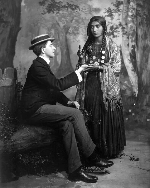 PALM-READING, c1910. A staged depiction of a Gypsy woman reading a mans palm. Photographed c1910