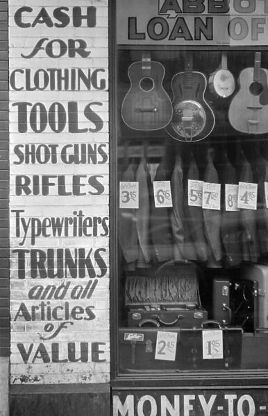 PAWN SHOP, c1940. Goods in the window of an American pawn shop. Photograph, c1940